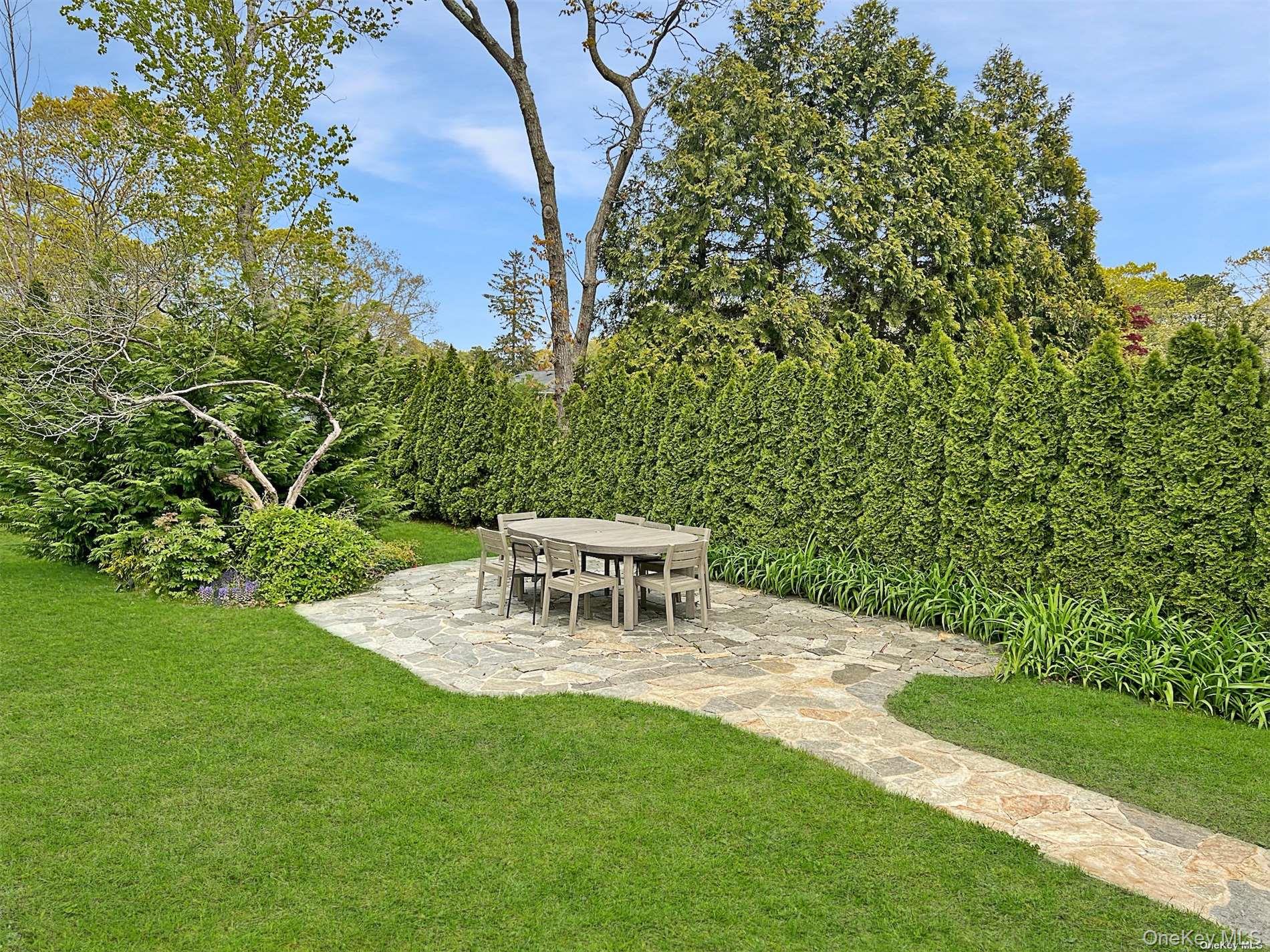 129 Lynncliff Road Hampton Bays, NY 11946 - Photo 16 of 19 a view of a chairs and table in the garden