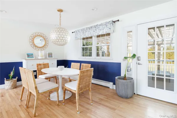 a view of a dining room with furniture large windows and wooden floor