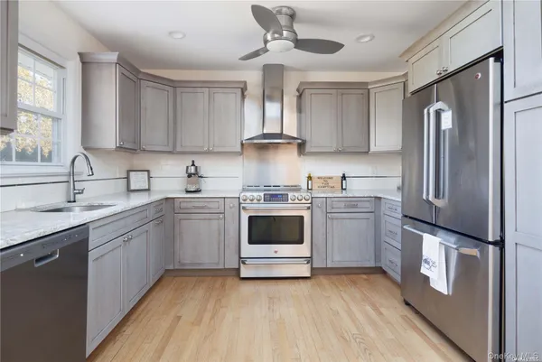 a kitchen with a stove sink and refrigerator