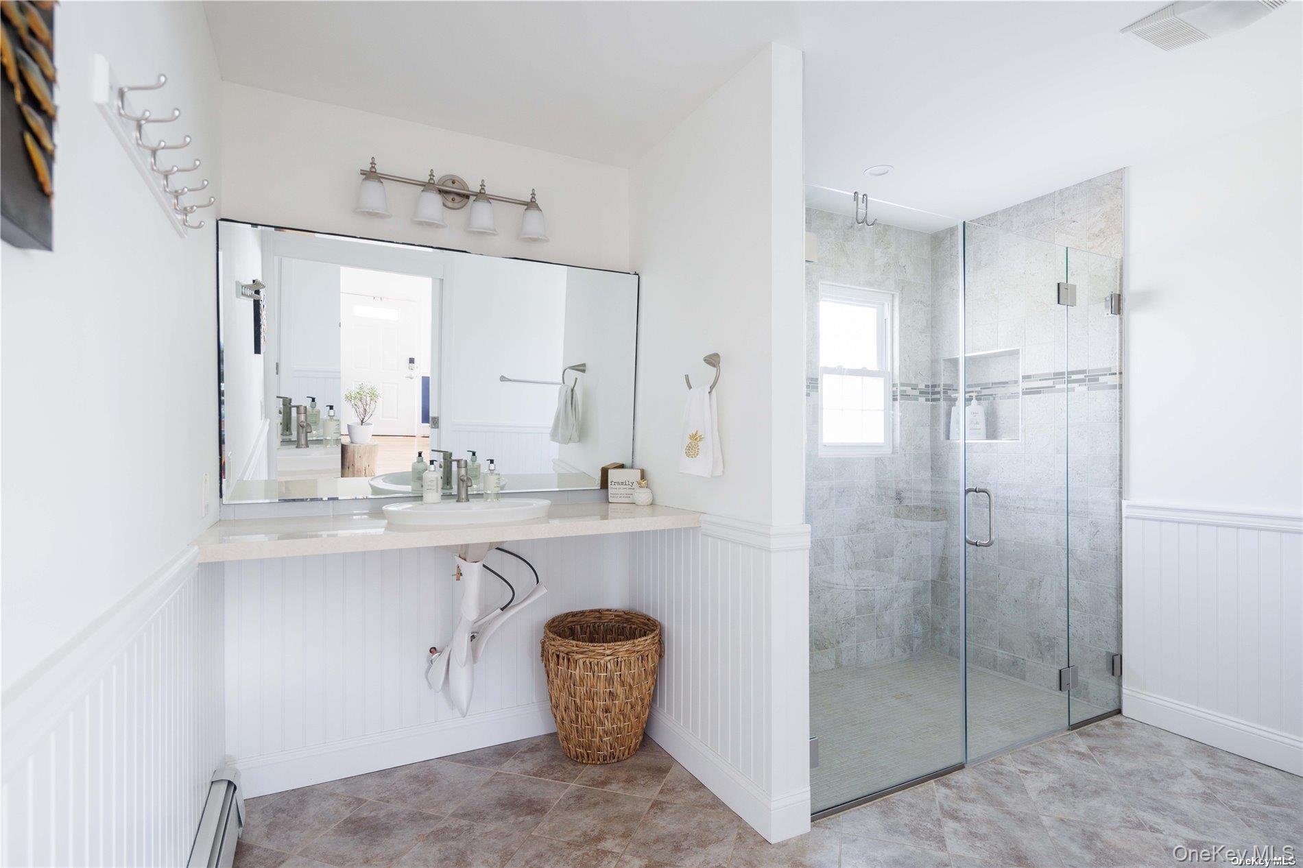 129 Lynncliff Road Hampton Bays, NY 11946 - Photo 10 of 24 a bathroom with a sink and a mirror