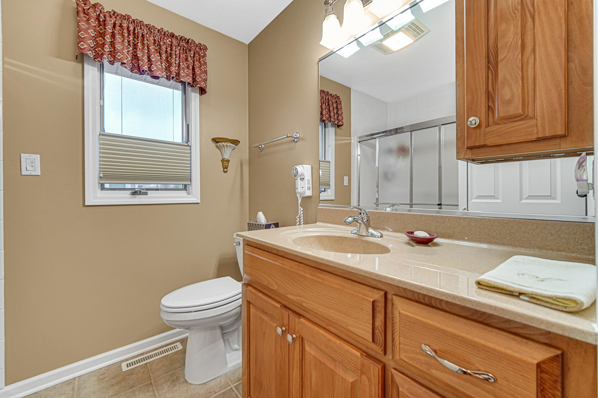 1718 Silver Hawk Drive Crown Point, IN 46307 - Photo 18 of 29 a bathroom with a sink a toilet and mirror