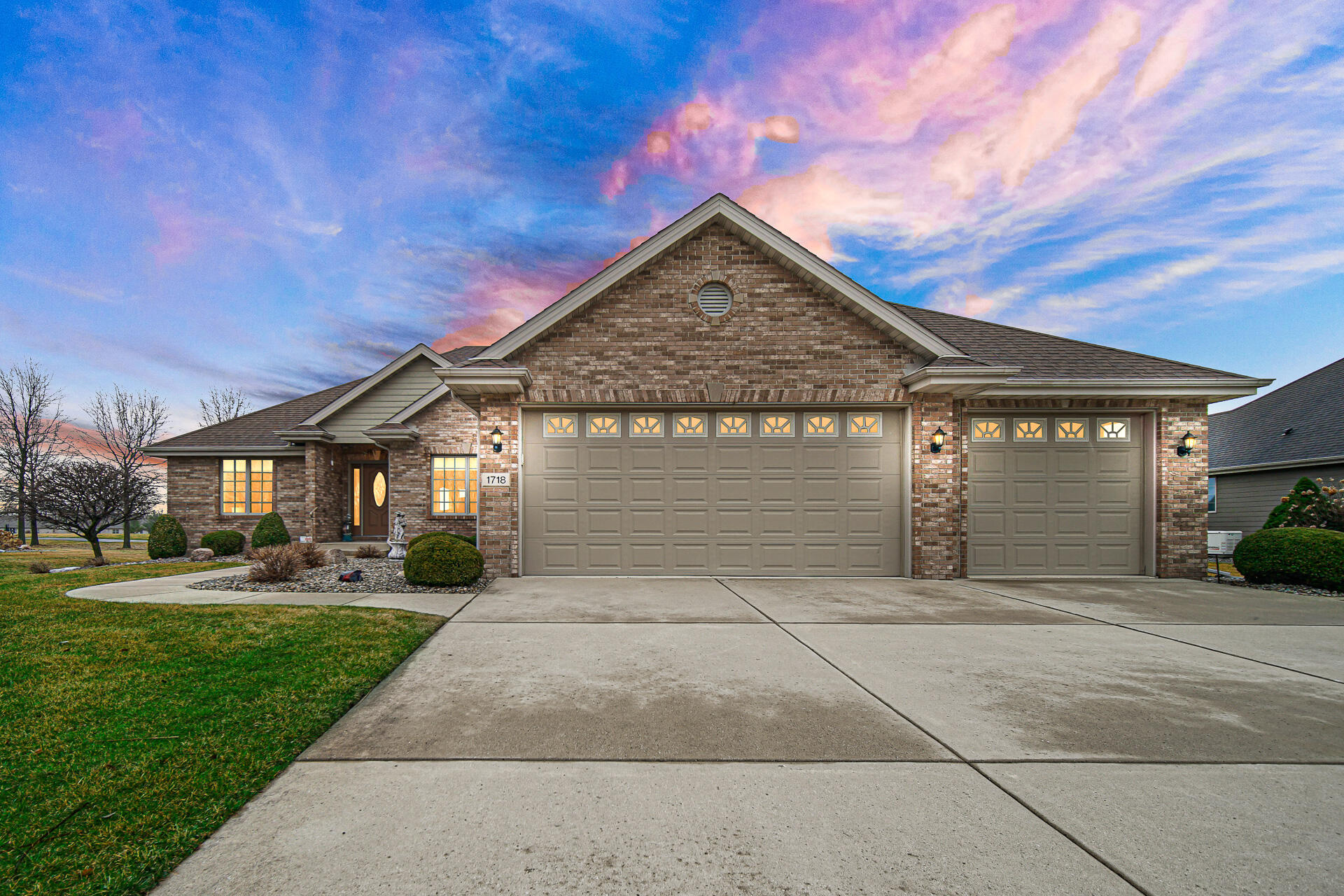 1718 Silver Hawk Drive Crown Point, IN 46307 - Photo 2 of 29 a front view of a house with a garden and trees