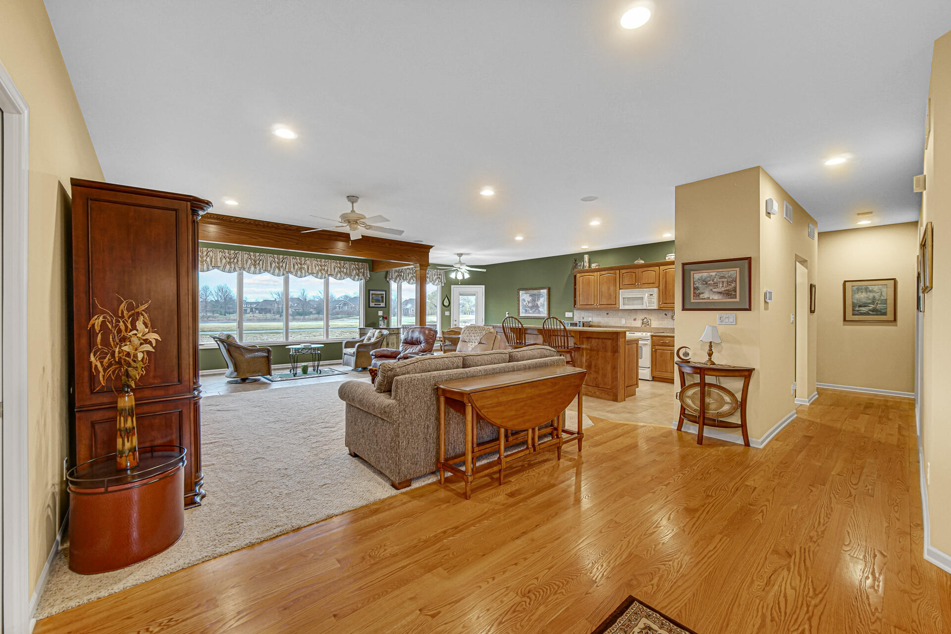 1718 Silver Hawk Drive Crown Point, IN 46307 - Photo 4 of 29 a living room with furniture a wooden floor and next to a window