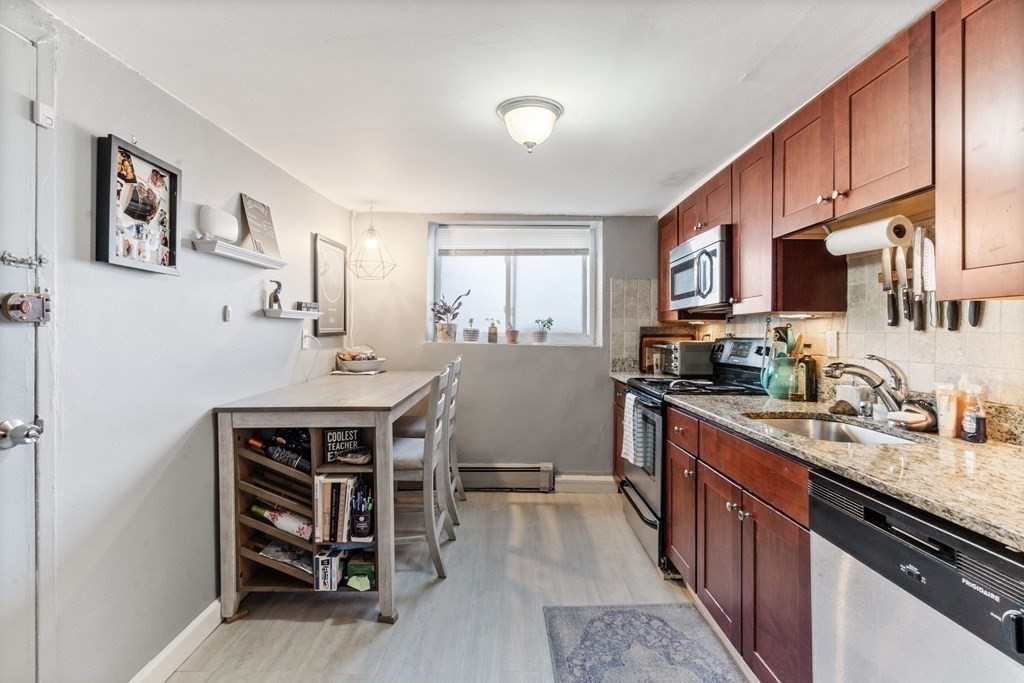 a kitchen with stainless steel appliances a stove sink microwave and cabinets