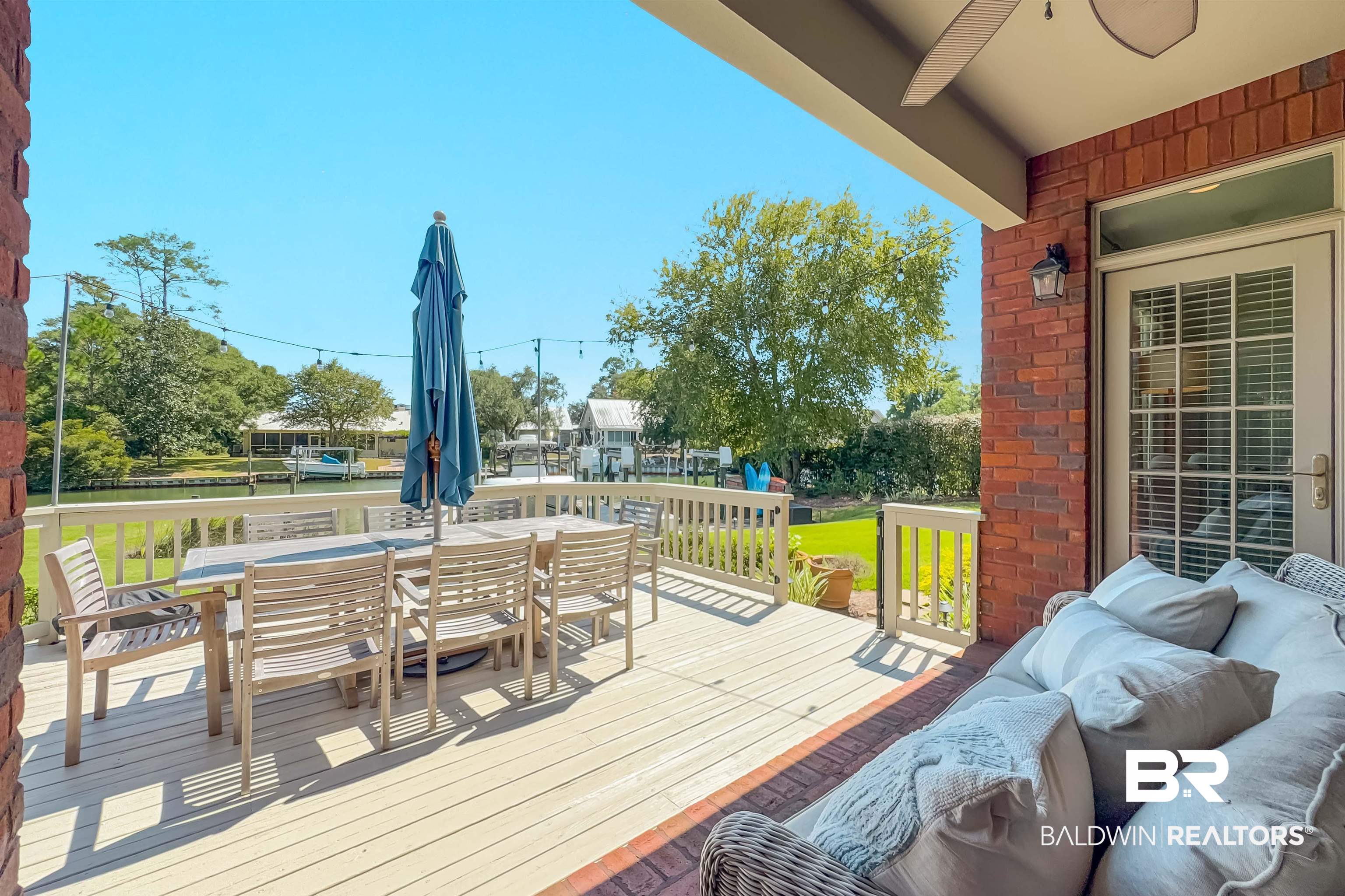 6630 East Quarry Drive Elberta, AL 36530 - Photo 53 of 63 Deck with a water view, outdoor dining area, and a ceiling fan