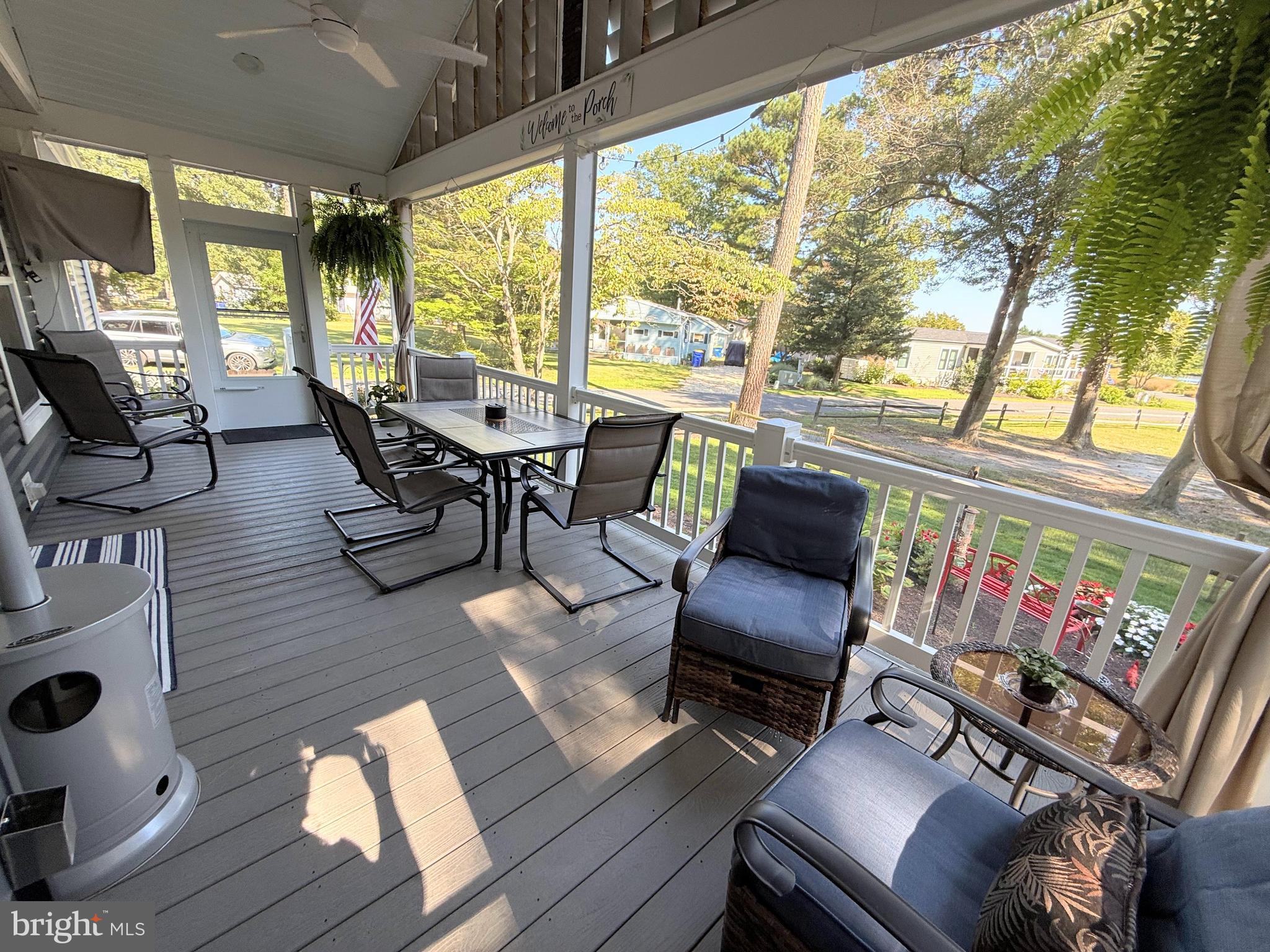 26908 Wood Duck Road, Unit 611 Long Neck, DE 19966 - Photo 16 of 80 a outdoor living space with furniture and a floor to ceiling window