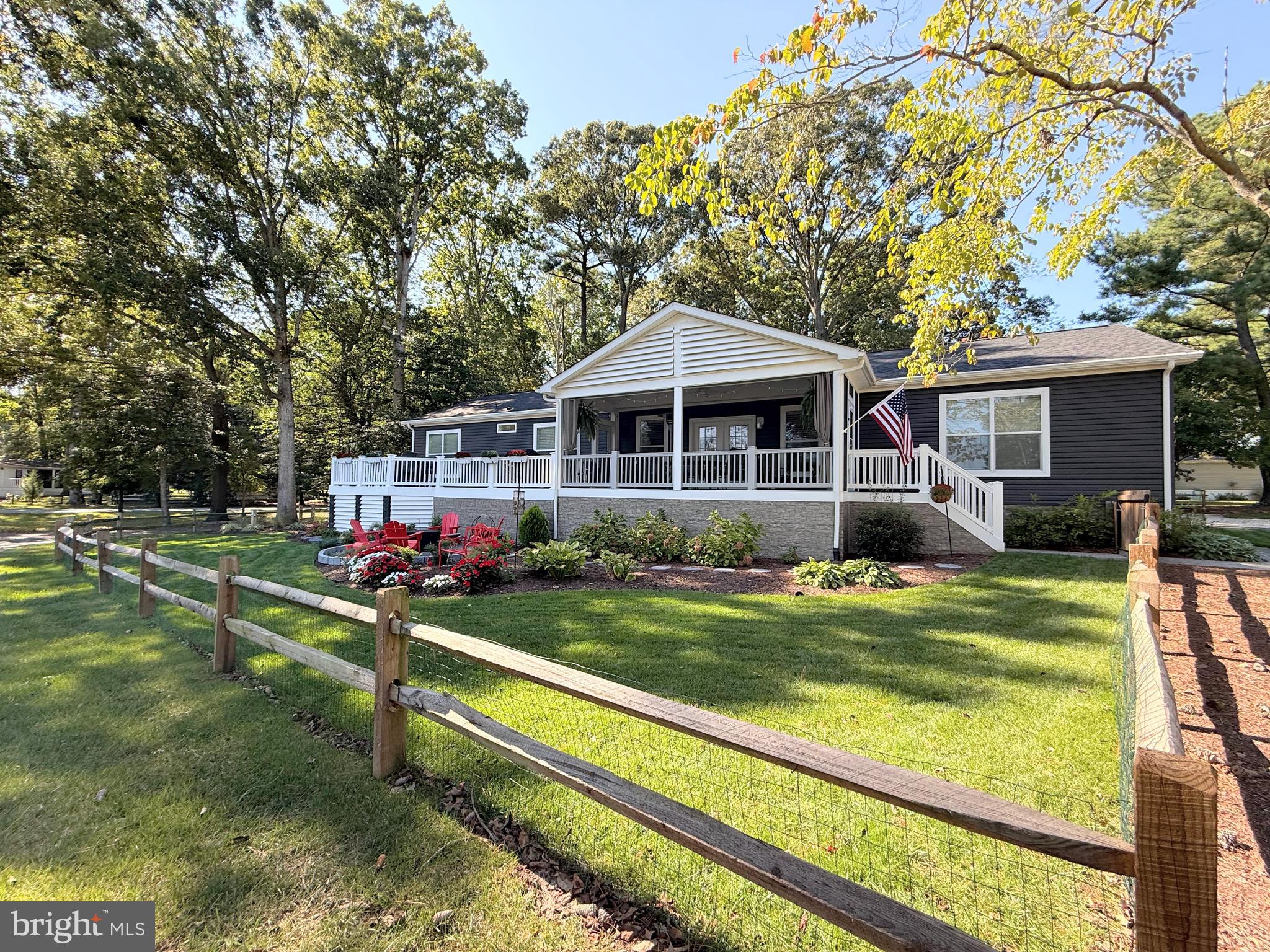 26908 Wood Duck Road, Unit 611 Long Neck, DE 19966 - Photo 3 of 80 a view of a house with a yard patio and fire pit