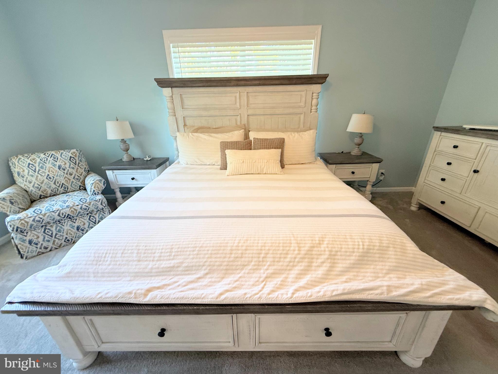 26908 Wood Duck Road, Unit 611 Long Neck, DE 19966 - Photo 45 of 80 a bedroom with a bed and window