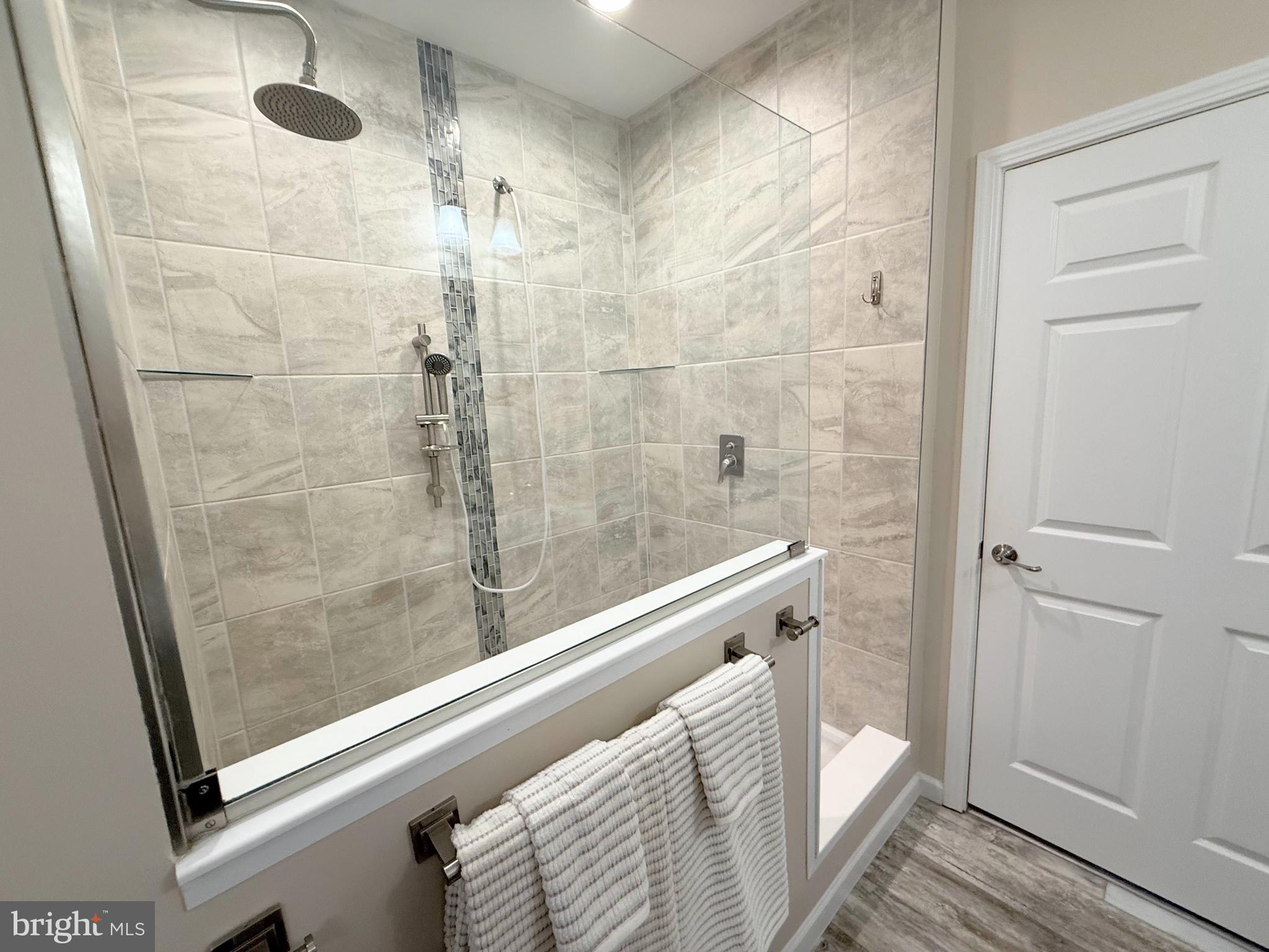 26908 Wood Duck Road, Unit 611 Long Neck, DE 19966 - Photo 48 of 80 a bathroom with a shower