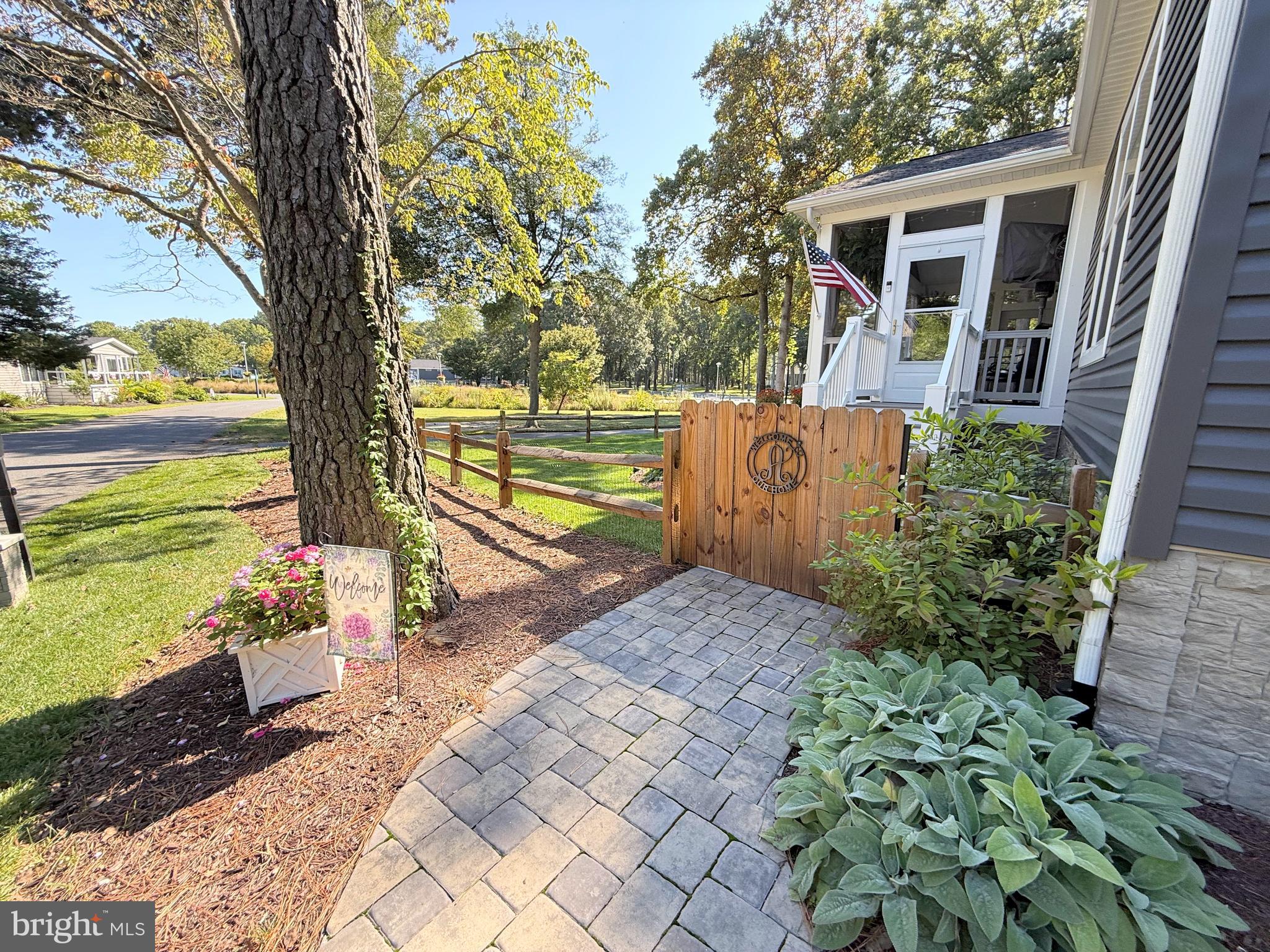 26908 Wood Duck Road, Unit 611 Long Neck, DE 19966 - Photo 5 of 80 a view of a pathway with a yard