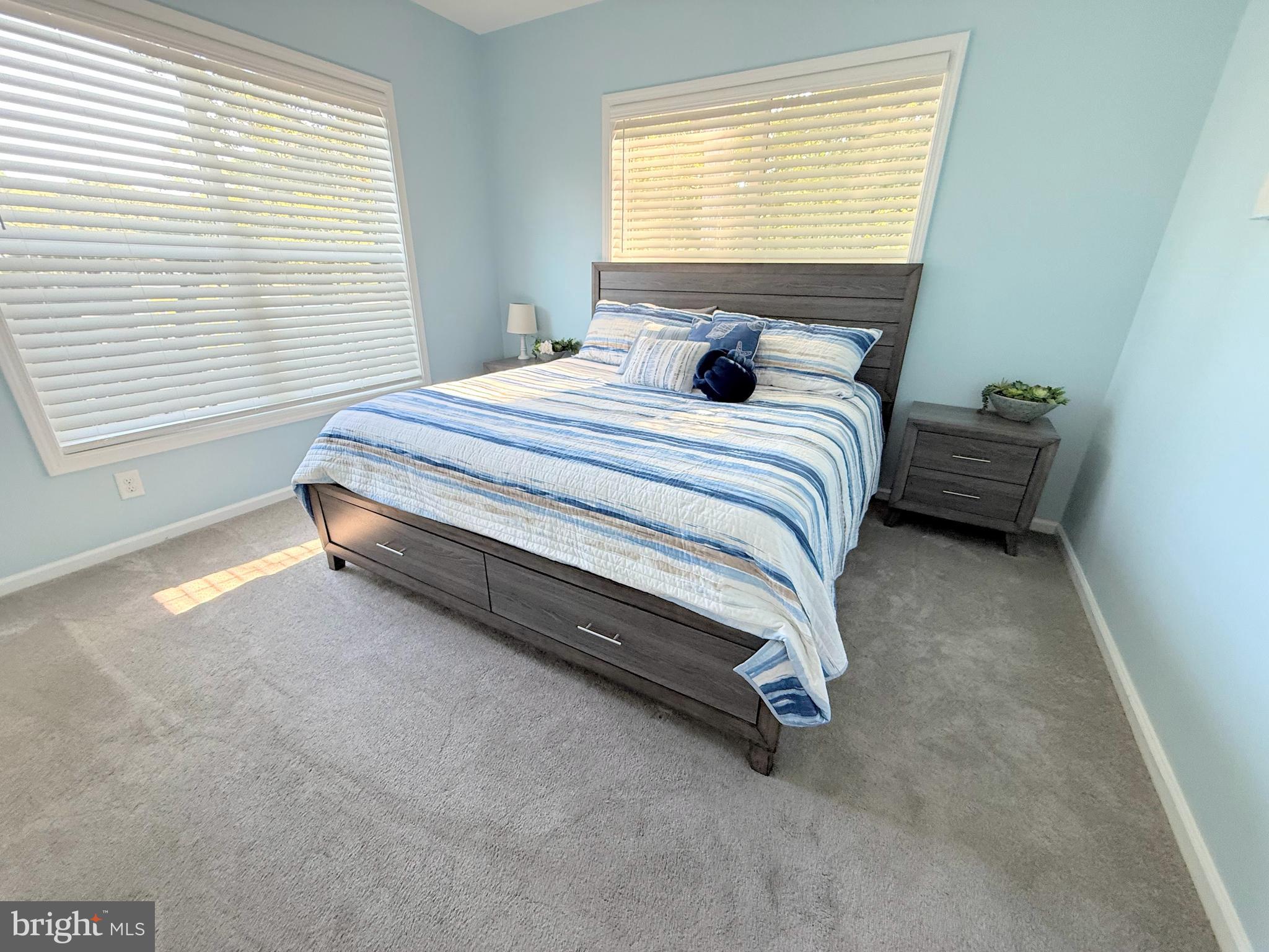 26908 Wood Duck Road, Unit 611 Long Neck, DE 19966 - Photo 55 of 80 a bedroom with a bed and a window