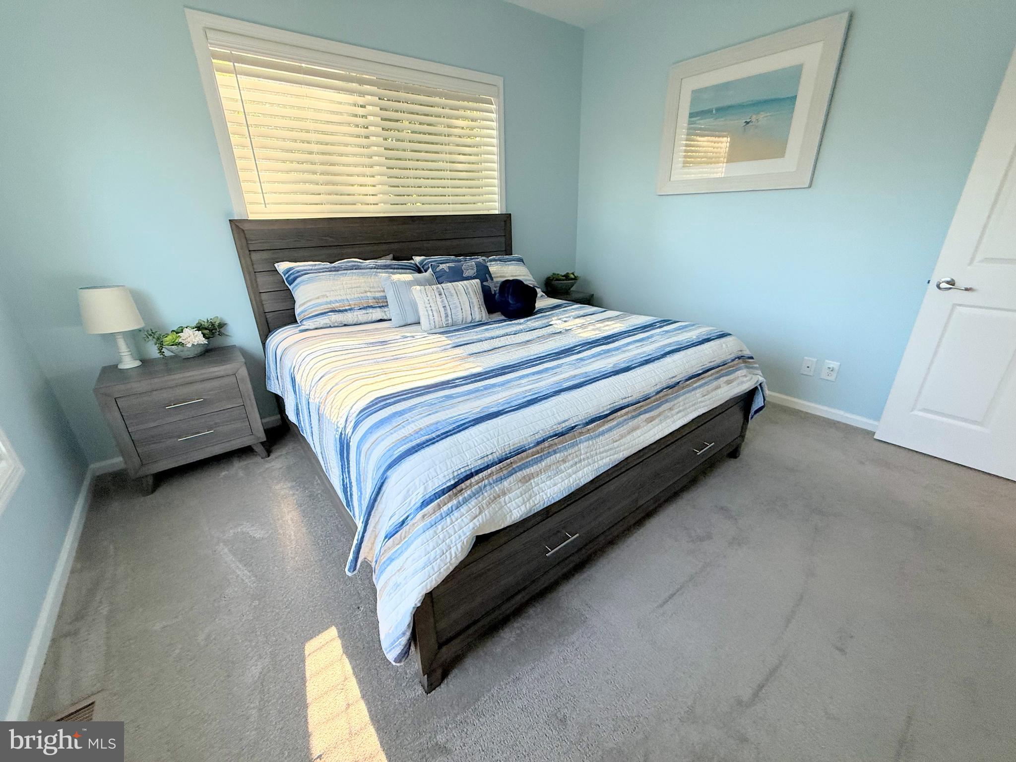 26908 Wood Duck Road, Unit 611 Long Neck, DE 19966 - Photo 56 of 80 a bedroom with a bed chair and a window