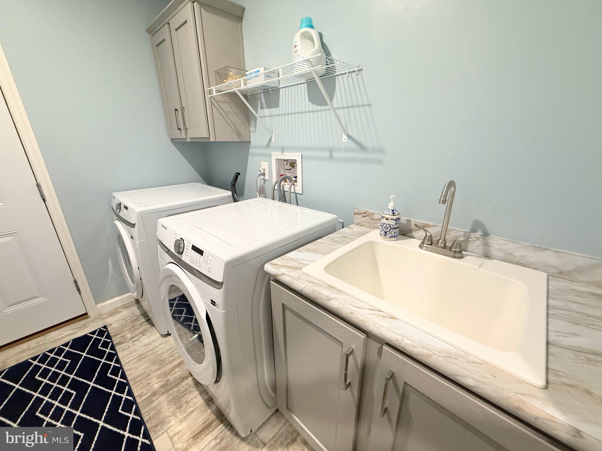26908 Wood Duck Road, Unit 611 Long Neck, DE 19966 - Photo 64 of 80 a utility room with dryer and washer