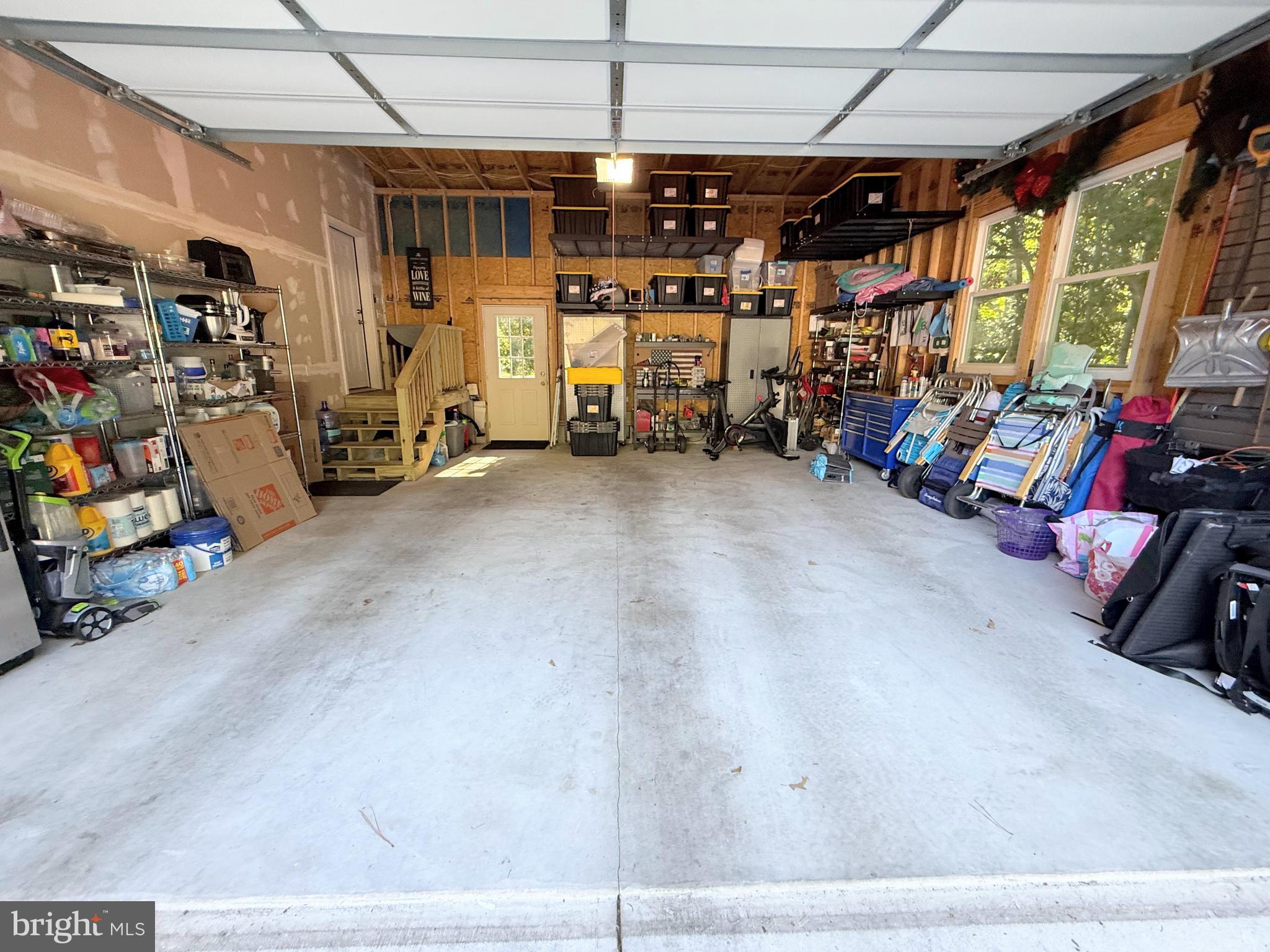 26908 Wood Duck Road, Unit 611 Long Neck, DE 19966 - Photo 68 of 80 a view of a garage with a bike and car