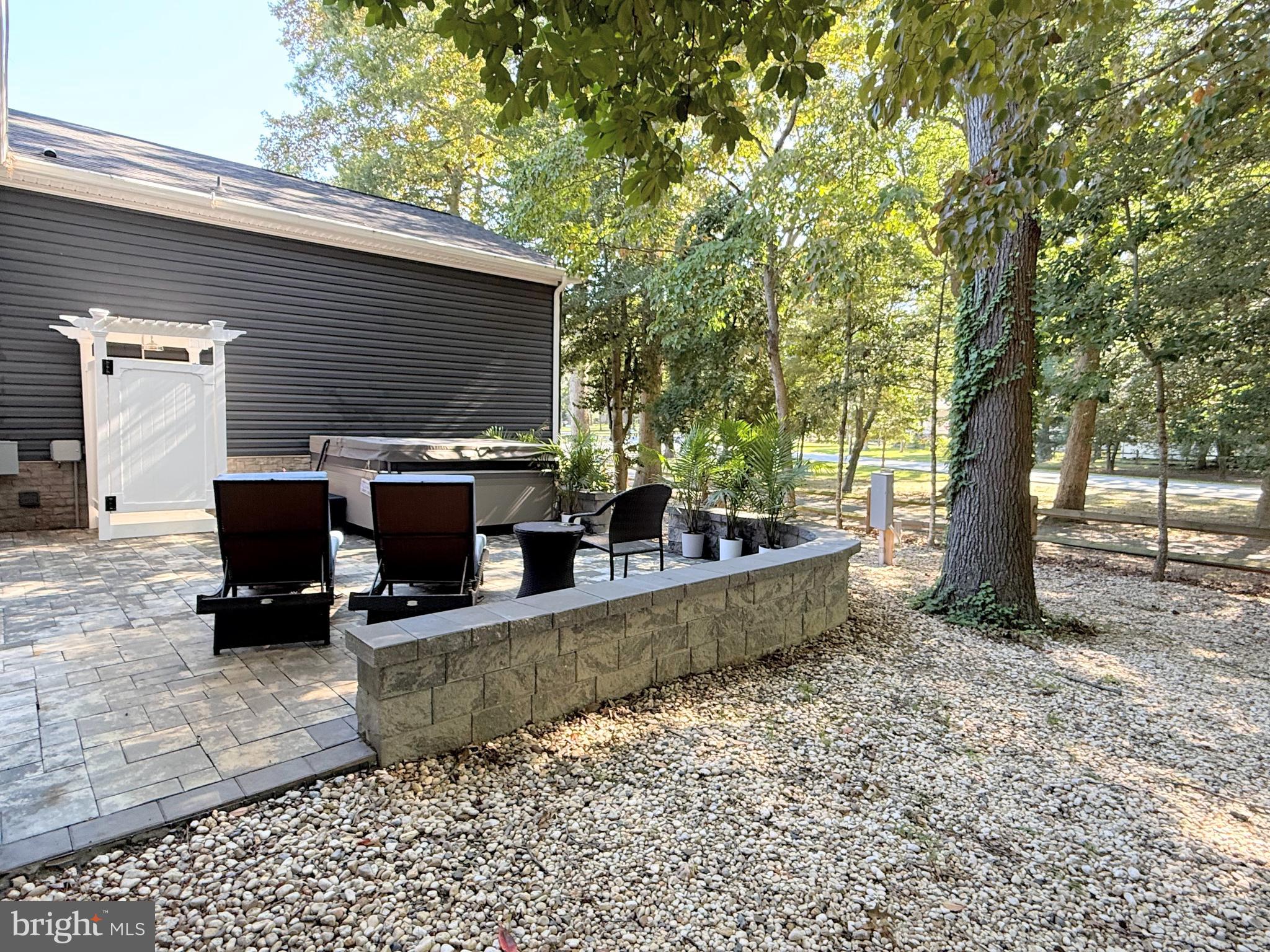 26908 Wood Duck Road, Unit 611 Long Neck, DE 19966 - Photo 74 of 80 a view of a house with backyard and sitting area
