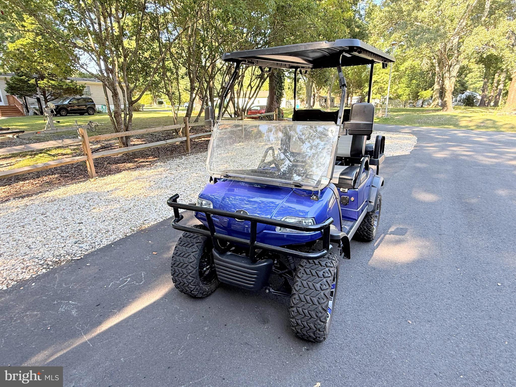 26908 Wood Duck Road, Unit 611 Long Neck, DE 19966 - Photo 78 of 80 a wooden bench sitting in middle of a yard