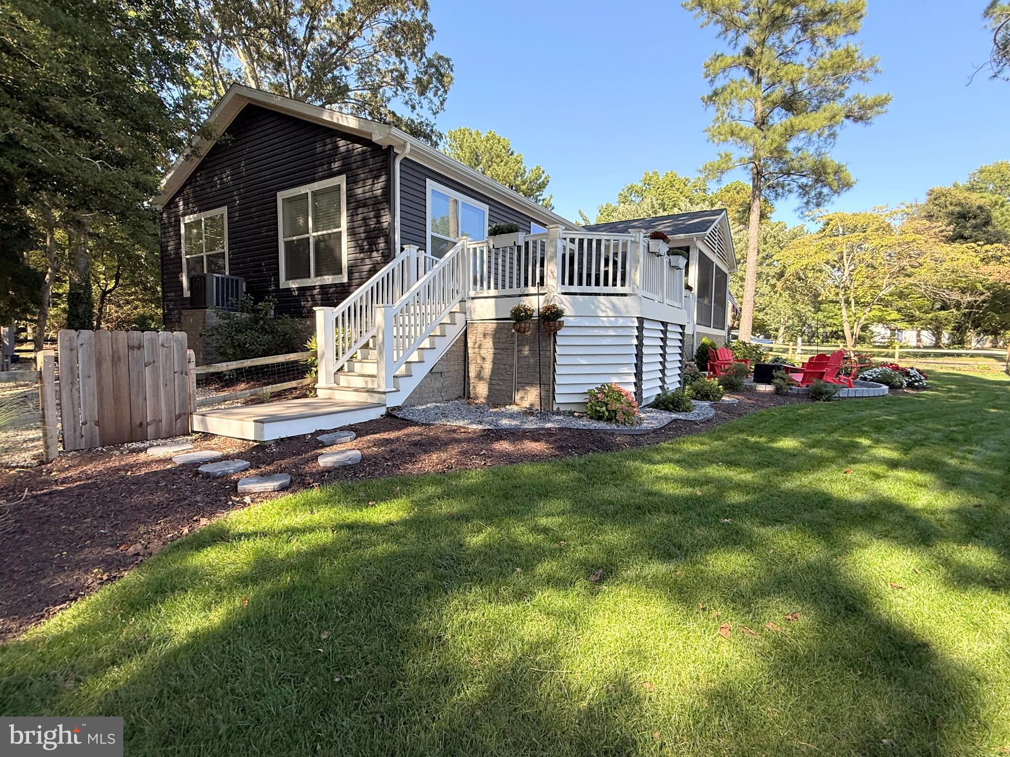 26908 Wood Duck Road, Unit 611 Long Neck, DE 19966 - Photo 10 of 80 a view of a house with backyard and sitting area