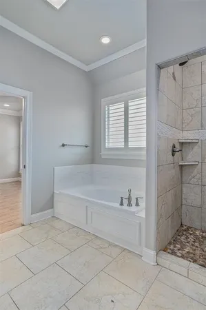 a spacious bathroom with a tub shower and a sink
