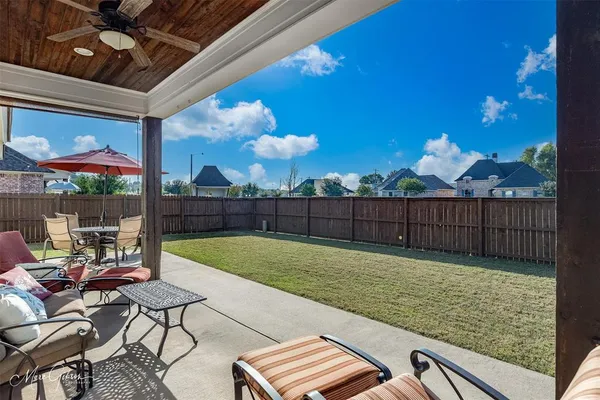 a view of a backyard with sitting area
