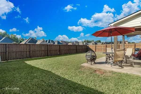a view of a backyard with sitting area