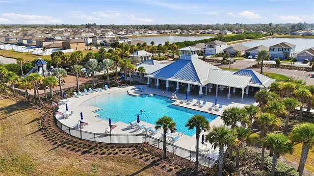 a view of a house with a swimming pool and mountains
