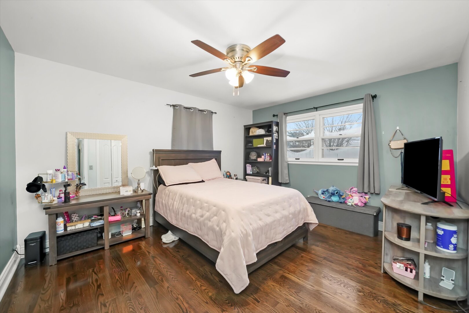 17702 Bernadine Street Lansing, IL 60438 - Photo 31 of 41 a bedroom with a bed table and flat screen tv