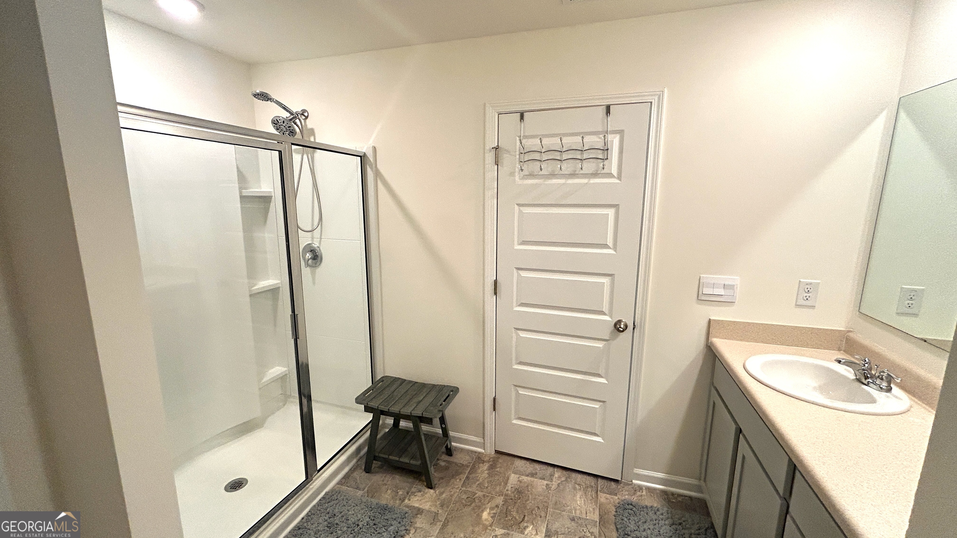 837 Taurus Drive Stockbridge, GA 30281 - Photo 12 of 20 a bathroom with a shower sink and mirror