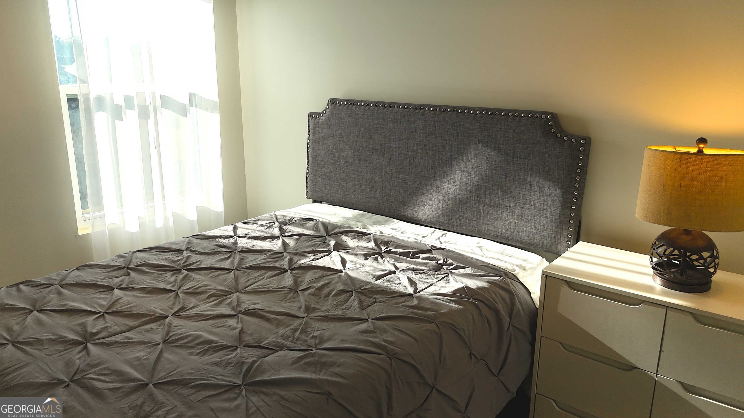 837 Taurus Drive Stockbridge, GA 30281 - Photo 14 of 20 a bedroom with a bed and a window