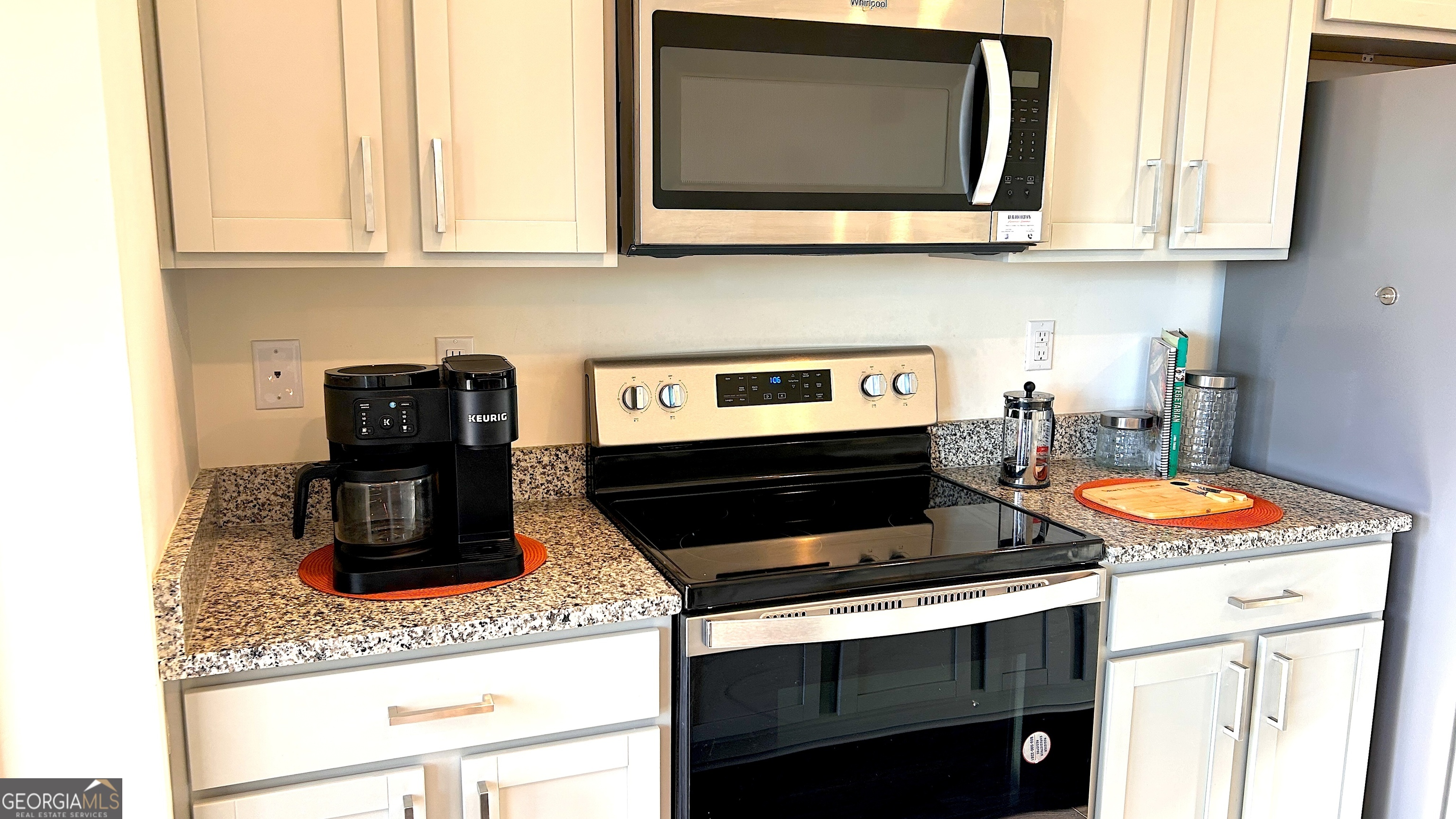 837 Taurus Drive Stockbridge, GA 30281 - Photo 5 of 20 a kitchen with stainless steel appliances granite countertop a stove and a microwave