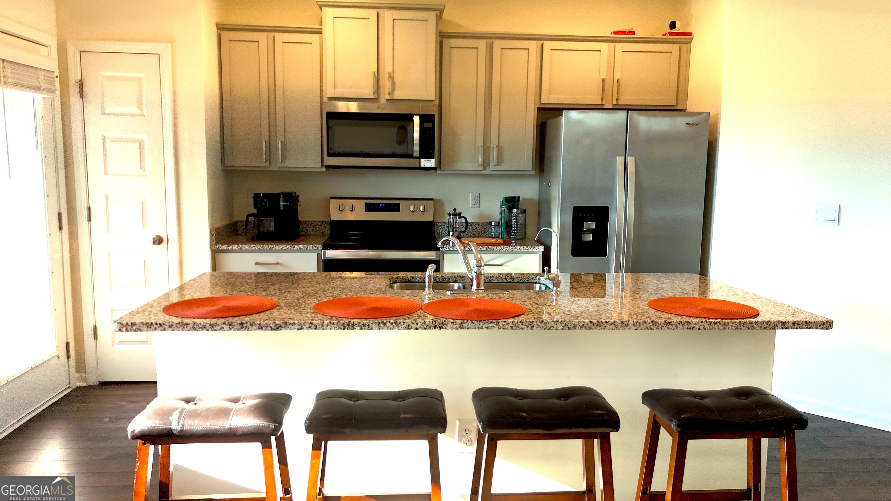 837 Taurus Drive Stockbridge, GA 30281 - Photo 6 of 20 a kitchen with stainless steel appliances kitchen island granite countertop a table and chairs