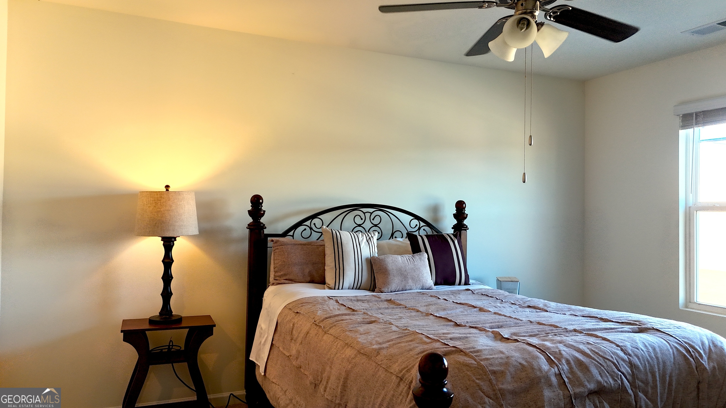 837 Taurus Drive Stockbridge, GA 30281 - Photo 10 of 20 a bedroom with a bed and a chandelier