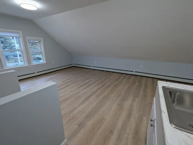 a view of room with window and wooden floor