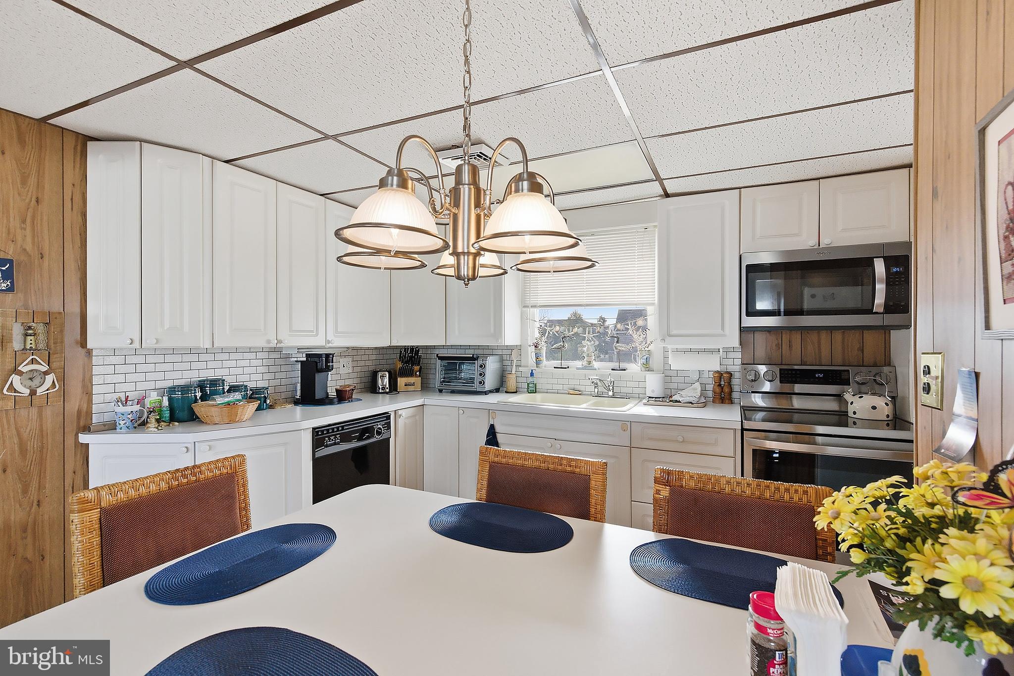 329 West 5th Street Ship Bottom, NJ 08008 - Photo 12 of 47 a kitchen with stainless steel appliances kitchen island granite countertop a sink and cabinets