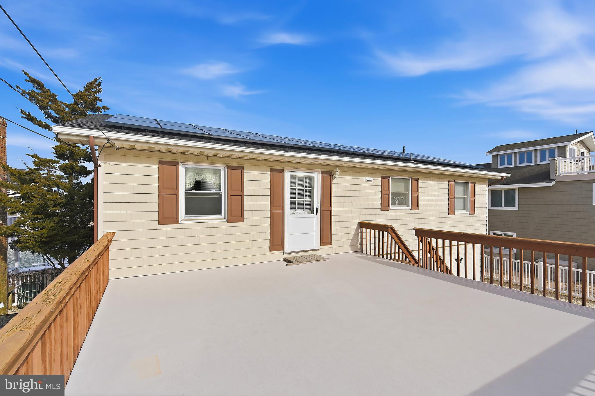 329 West 5th Street Ship Bottom, NJ 08008 - Photo 14 of 47 a view of a house with a roof deck