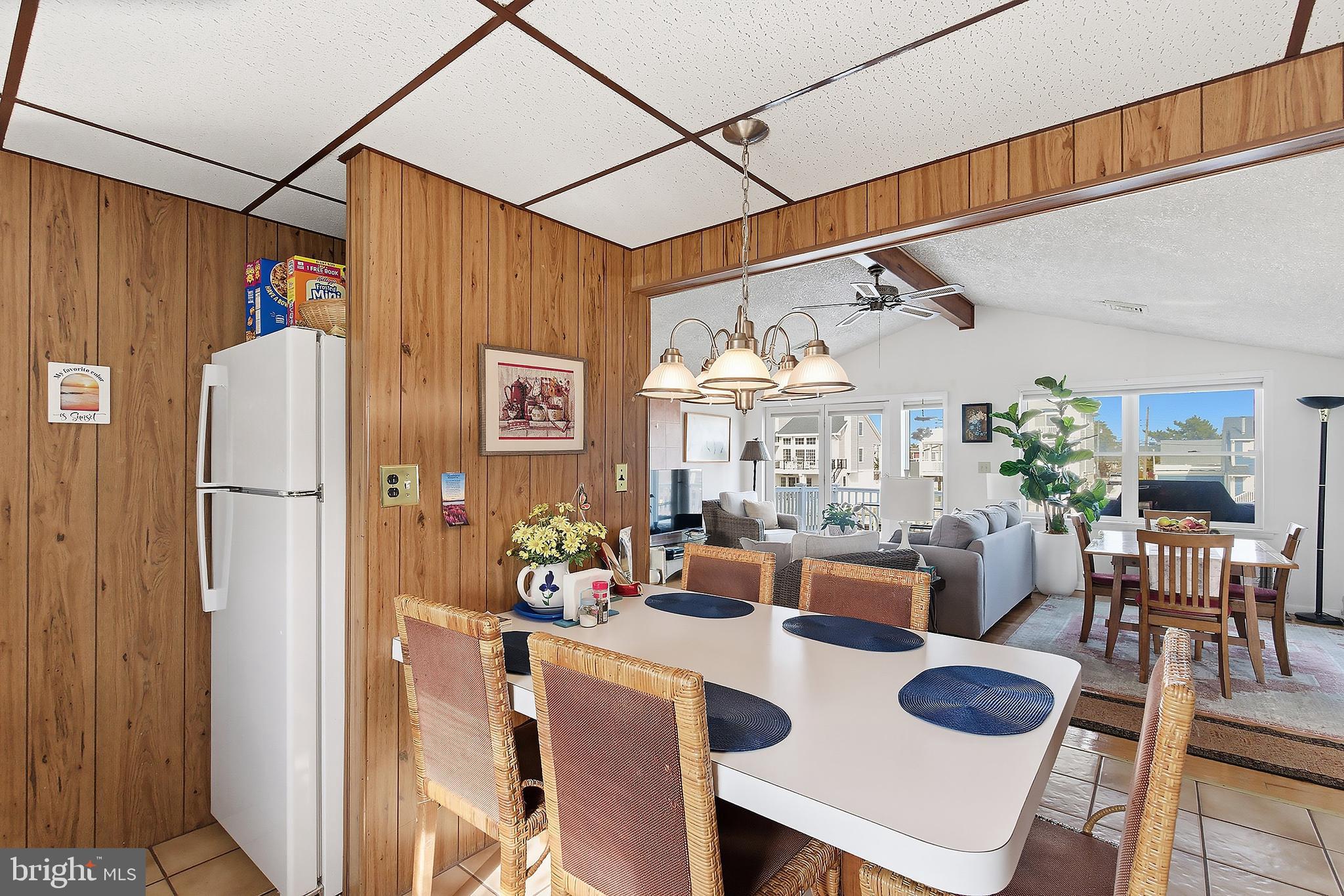 329 West 5th Street Ship Bottom, NJ 08008 - Photo 16 of 47 a dining room with furniture a chandelier and kitchen view