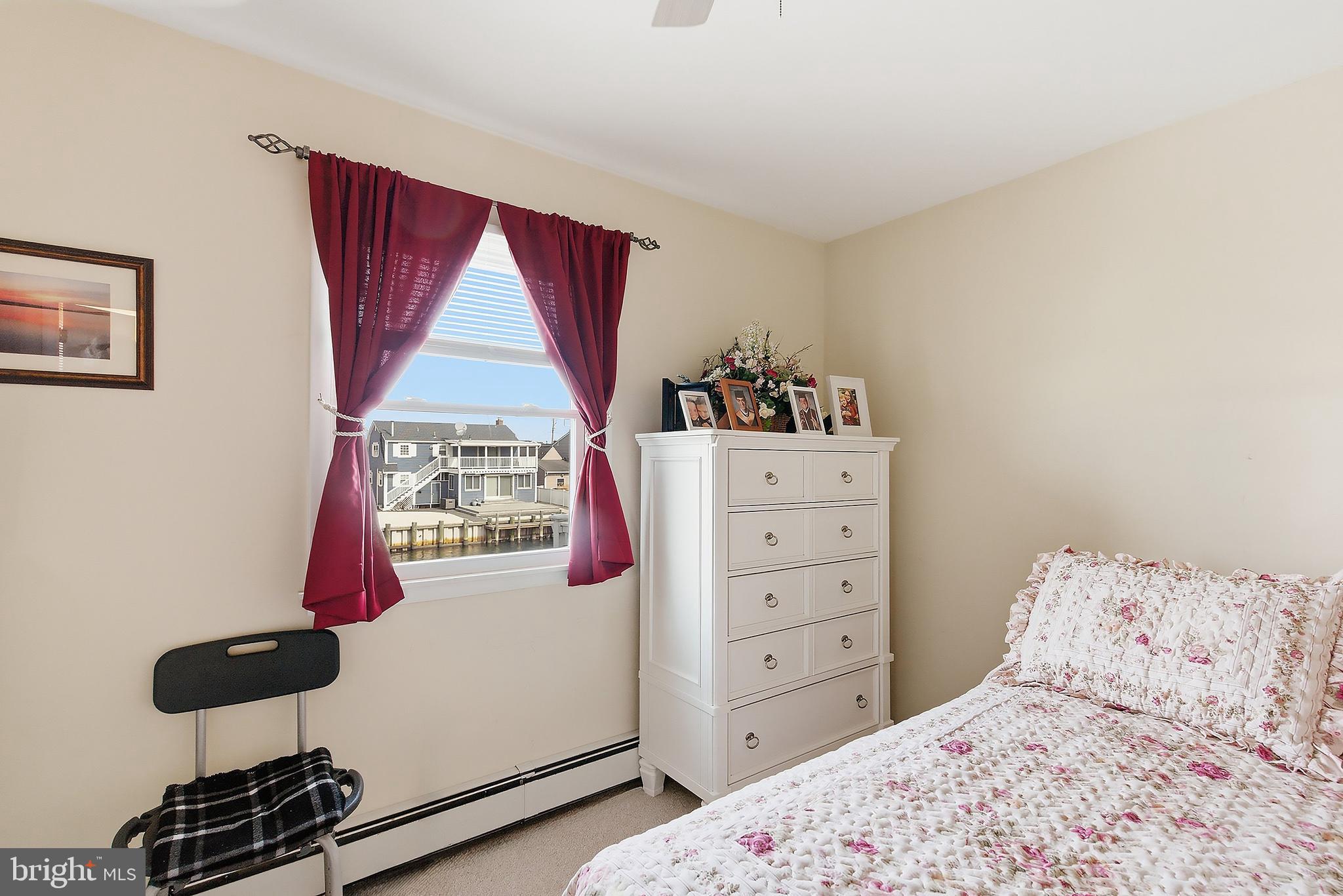 329 West 5th Street Ship Bottom, NJ 08008 - Photo 24 of 47 a bedroom with a bed and wooden floor