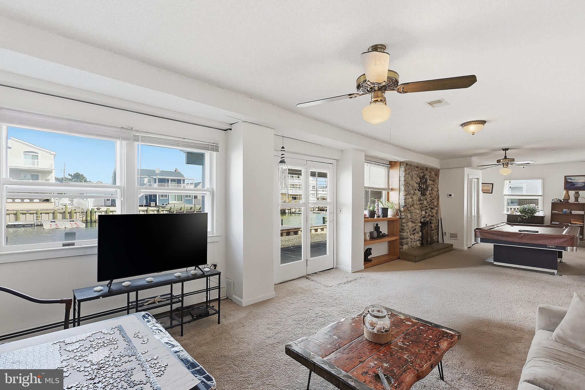329 West 5th Street Ship Bottom, NJ 08008 - Photo 29 of 47 a living room with furniture and a flat screen tv