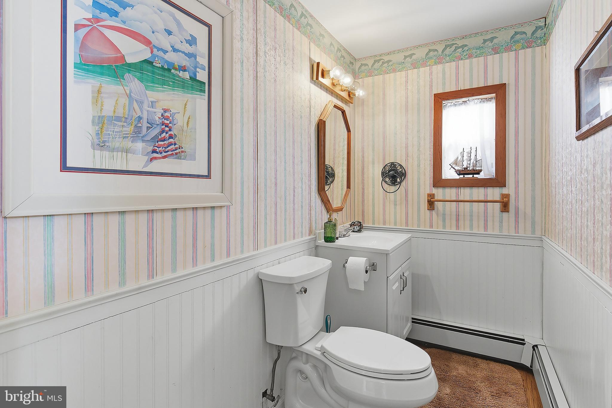 329 West 5th Street Ship Bottom, NJ 08008 - Photo 30 of 47 a white toilet sitting next to a bathroom sink