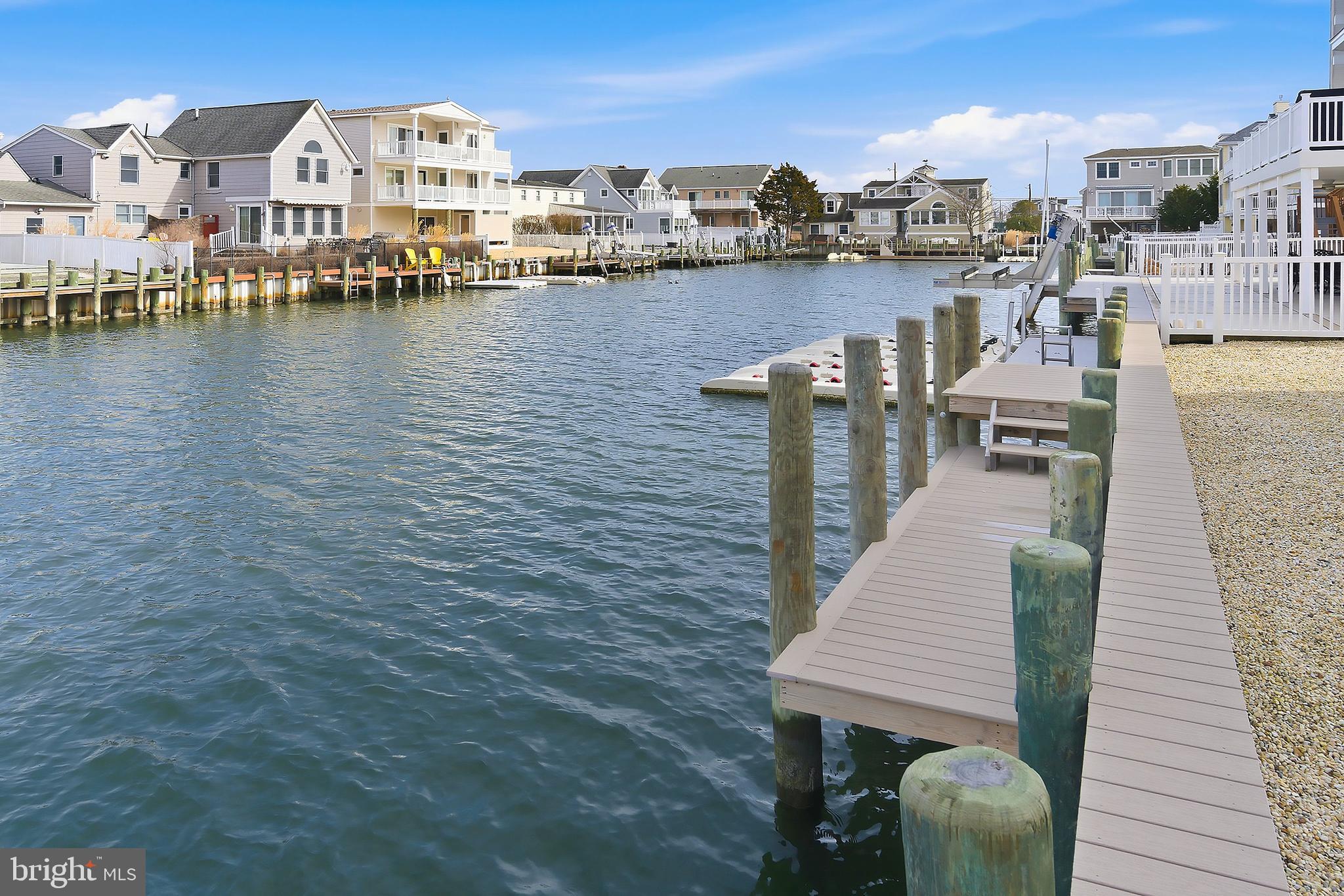 329 West 5th Street Ship Bottom, NJ 08008 - Photo 39 of 47 a view of a lake with boats and trees in the background