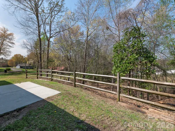 a view of a backyard with wooden fence