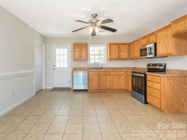 a kitchen with granite countertop a sink and a stove top oven
