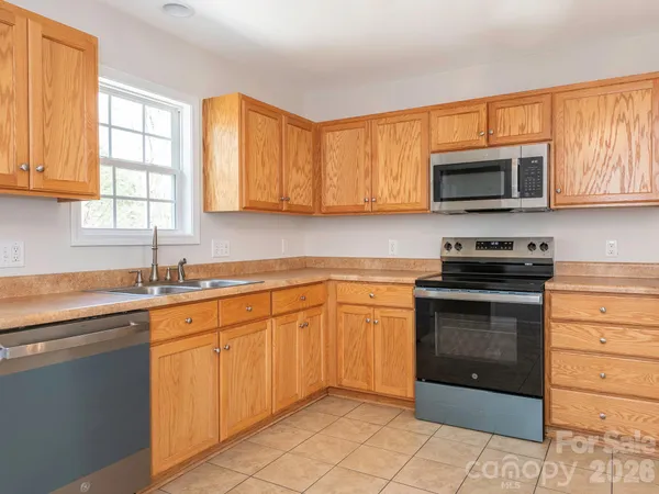 a kitchen with sink cabinets and window