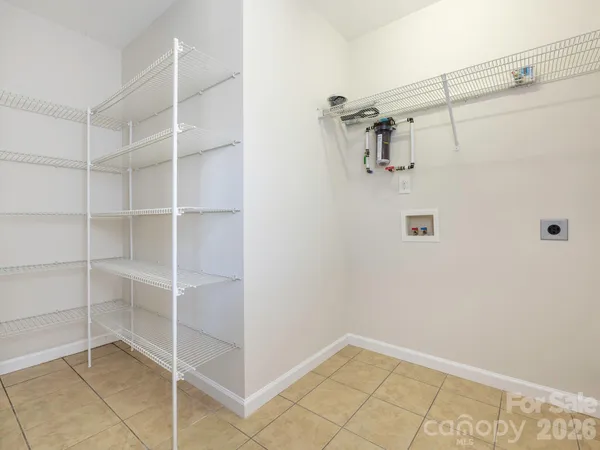 an empty room with windows and ceiling fan