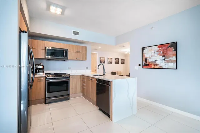 a kitchen with stainless steel appliances and cabinets