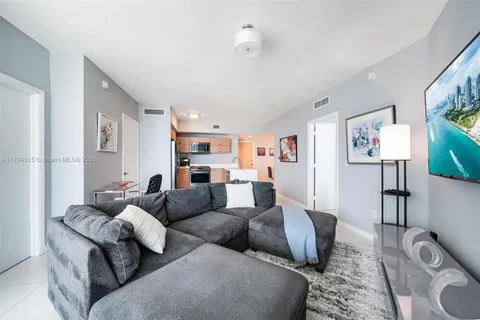 a view of a bedroom with a balcony and furniture