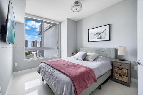 a bedroom with a bed and a painting on the wall