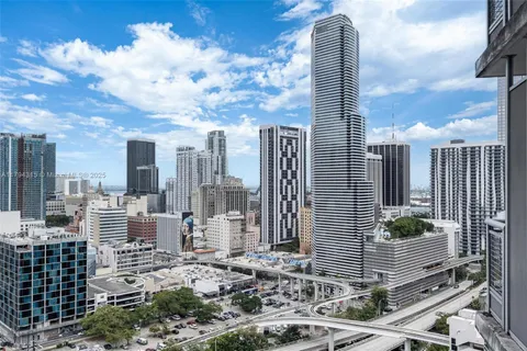 a living room with furniture a rug and a chandelier