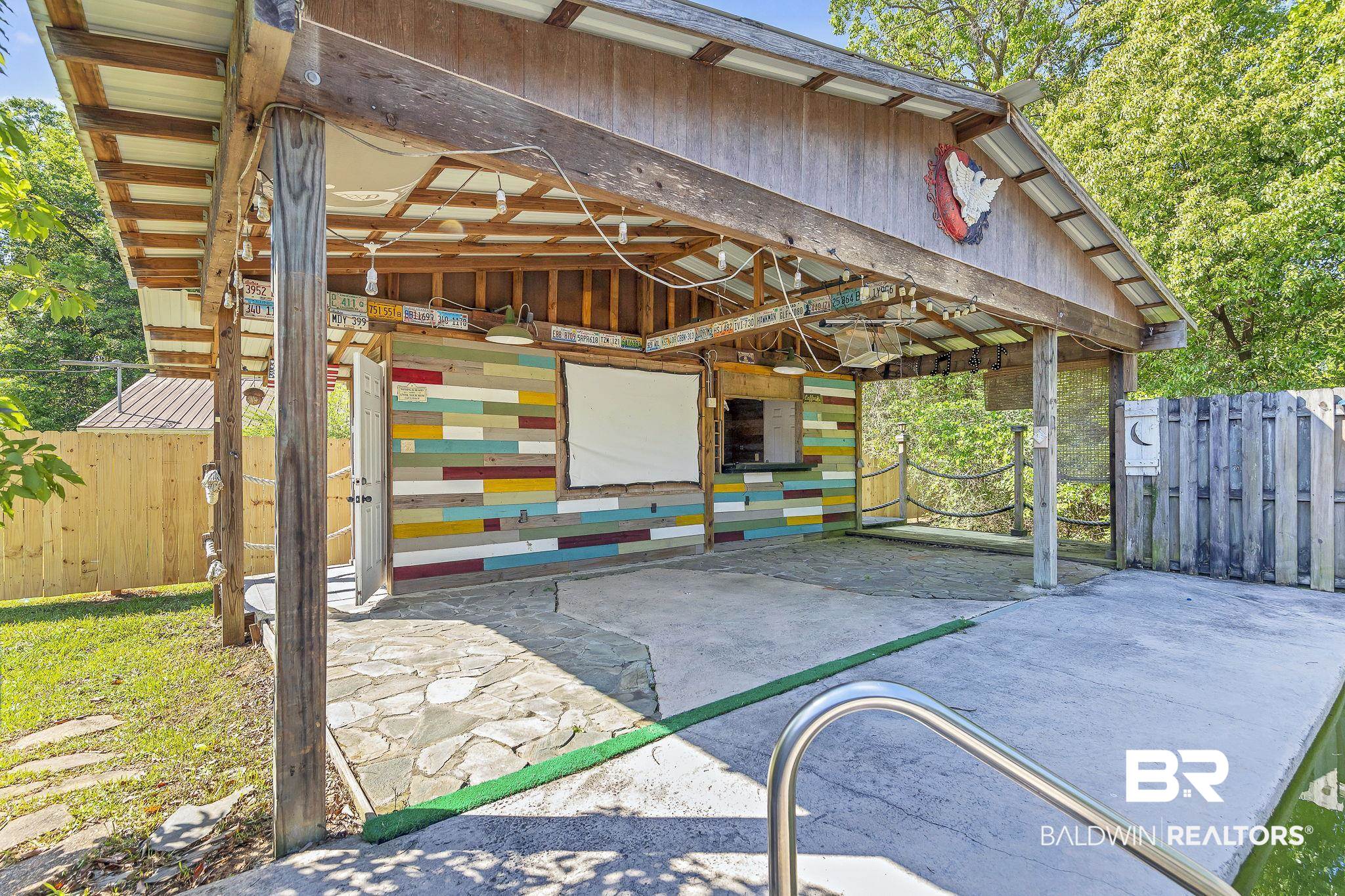 11964 Stroh Road Daphne, AL 36527 - Photo 52 of 58 View of patio featuring an exterior structure, a carport, and an outdoor structure