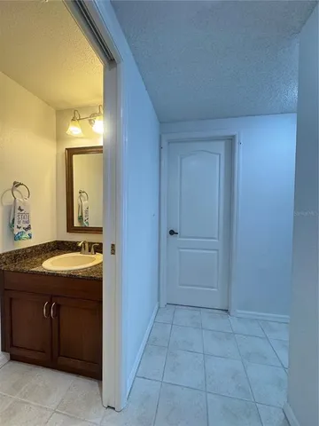 a bathroom with a granite countertop sink and a mirror