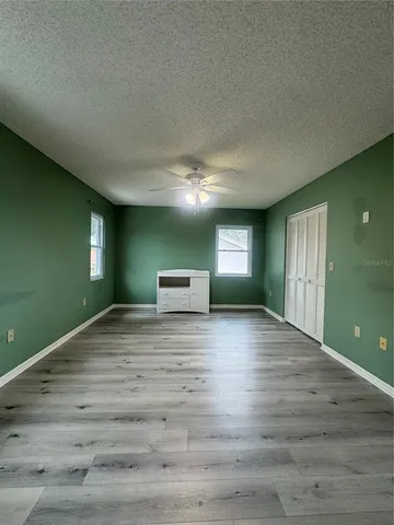 a view of empty room with window and fireplace